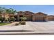 Charming home featuring a three-car garage, desert landscaping, and a stone-accented entry at 27421 N 22Nd Ln, Phoenix, AZ 85085