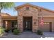 Charming home featuring a stone-accented entry, desert landscaping, and a brick walkway at 27421 N 22Nd Ln, Phoenix, AZ 85085
