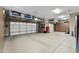 Spacious three-car garage with epoxy floors, overhead storage racks, and built-in cabinets providing ample storage solutions at 27421 N 22Nd Ln, Phoenix, AZ 85085