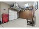 Spacious garage featuring an epoxy floor, white door, storage cabinets, and a convenient tool chest at 27421 N 22Nd Ln, Phoenix, AZ 85085