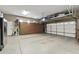 Clean garage with epoxy flooring, built-in storage cabinets, and overhead racks, creating a well-organized space at 27421 N 22Nd Ln, Phoenix, AZ 85085