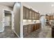 Hallway features custom cabinets with under-lighting and tile flooring, connecting to the kitchen area at 27421 N 22Nd Ln, Phoenix, AZ 85085