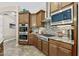 Close up of kitchen with stainless steel appliances, granite countertops, and custom backsplash at 27421 N 22Nd Ln, Phoenix, AZ 85085