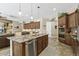 Open kitchen with stainless steel appliances, large island, and breakfast bar seating at 27421 N 22Nd Ln, Phoenix, AZ 85085