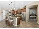 This open concept kitchen boasts a large island with seating, stainless appliances, and pendant lighting at 27421 N 22Nd Ln, Phoenix, AZ 85085