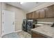 Practical laundry room includes a washer, dryer, ample cabinet storage, and a utility sink at 27421 N 22Nd Ln, Phoenix, AZ 85085