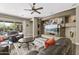 Bright living room boasts neutral walls, stone accent wall, decorative rug, and access to the patio at 27421 N 22Nd Ln, Phoenix, AZ 85085
