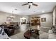 Open-concept living room with stone floors, dining area, and view of the office at 27421 N 22Nd Ln, Phoenix, AZ 85085