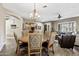 Open floor plan connecting dining room and living room with neutral tones at 27421 N 22Nd Ln, Phoenix, AZ 85085