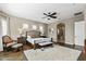Large main bedroom with hardwood flooring, fluffy rug, ceiling fan, and lots of natural light at 27421 N 22Nd Ln, Phoenix, AZ 85085