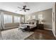 Tranquil main bedroom with dark-stained wood floors, natural light, ceiling fan, and stylish decor at 27421 N 22Nd Ln, Phoenix, AZ 85085