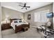 Main bedroom featuring a ceiling fan, plantation shutters, and neutral paint at 27421 N 22Nd Ln, Phoenix, AZ 85085