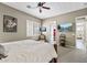 Main bedroom featuring ceiling fan, access to the bathroom, and neutral paint at 27421 N 22Nd Ln, Phoenix, AZ 85085