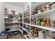 Well-organized pantry featuring rows of shelving filled with food and supplies, offering ample storage space in the kitchen at 27421 N 22Nd Ln, Phoenix, AZ 85085