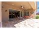 Covered patio with travertine floor and view of an expansive sliding glass door and the home's interior at 27421 N 22Nd Ln, Phoenix, AZ 85085