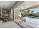 Inviting covered patio overlooks the sparkling pool and landscaped backyard, accessed by sliding doors at 27421 N 22Nd Ln, Phoenix, AZ 85085