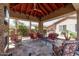 Inviting covered patio space with fireplace, ceiling fan, and comfortable seating at 27421 N 22Nd Ln, Phoenix, AZ 85085