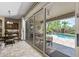 Covered patio with outdoor dining area and view of the pool, accessed through large sliding glass doors at 27421 N 22Nd Ln, Phoenix, AZ 85085