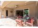 Spacious covered patio with travertine flooring offering beautiful views of the outdoor pool and landscaped yard at 27421 N 22Nd Ln, Phoenix, AZ 85085