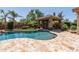 Stunning backyard with a sparkling pool, lush landscaping, and a cozy cabana with a fireplace at 27421 N 22Nd Ln, Phoenix, AZ 85085