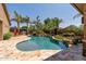 Beautiful pool with stone accents, tropical landscaping, and an outdoor grill area, creating an inviting backyard retreat at 27421 N 22Nd Ln, Phoenix, AZ 85085