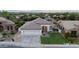 Stunning aerial view of a well-kept single-story home with a pristine lawn, three-car garage, and beautiful landscaping in a quiet neighborhood at 2982 S Holguin Way, Chandler, AZ 85286