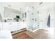Light, bright bathroom with glass shower, white cabinets and natural wood-look floors at 2982 S Holguin Way, Chandler, AZ 85286