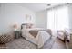 Cozy bedroom with decorative rug, light walls, and matching bedside lamps and tables at 2982 S Holguin Way, Chandler, AZ 85286