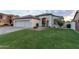 Lovely single-story home showcases a lush green lawn, a spacious three-car garage, and inviting front yard landscaping for great curb appeal at 2982 S Holguin Way, Chandler, AZ 85286