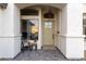 Inviting front porch features a cozy seating area, stylish decor, and a welcoming entrance to this beautifully maintained home at 2982 S Holguin Way, Chandler, AZ 85286