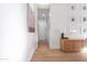 Bright hallway featuring wood-look flooring, white walls, and modern decor, creating a clean and inviting space at 2982 S Holguin Way, Chandler, AZ 85286