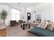 Beautiful living room with ample seating, a large window, and modern décor provides a comfortable and inviting space for relaxation at 2982 S Holguin Way, Chandler, AZ 85286