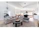Spacious living room features a large sectional sofa, stylish decor, and an open layout connecting to the kitchen and dining area at 2982 S Holguin Way, Chandler, AZ 85286