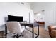 Bright home office featuring a modern desk, comfortable chair, and view into the open-plan living area at 2982 S Holguin Way, Chandler, AZ 85286