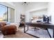 Bright home office with a modern desk, comfortable seating, and ample natural light creates an ideal workspace for productivity at 2982 S Holguin Way, Chandler, AZ 85286