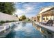 Inviting backyard pool with water features, lounge chairs, and a covered patio for relaxing and entertaining at 2982 S Holguin Way, Chandler, AZ 85286