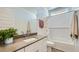 Bright bathroom with white cabinets, gray countertop, vanity, and bathtub with white subway tile and shower at 3344 S Lotus Ave, Mesa, AZ 85212
