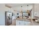 Open concept kitchen with stainless steel appliances and central island at 3344 S Lotus Ave, Mesa, AZ 85212