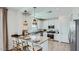 Modern kitchen with quartz countertops, island with seating and stainless-steel appliances at 3344 S Lotus Ave, Mesa, AZ 85212