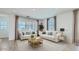 Inviting living room featuring neutral tones, two sofas and two large windows at 3344 S Lotus Ave, Mesa, AZ 85212