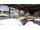 Community outdoor poolside lounge area featuring an open-air fireplace, outdoor seating and ample dining space at 3344 S Lotus Ave, Mesa, AZ 85212