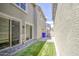 Backyard featuring artificial grass, a paver patio, and private fencing at 3893 E Gideon Way, Gilbert, AZ 85296