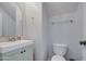 Neat half bathroom featuring a sink with a mint cabinet and a toilet at 3893 E Gideon Way, Gilbert, AZ 85296