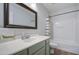 Bathroom featuring a vanity, framed mirror, and shower-tub combo at 3893 E Gideon Way, Gilbert, AZ 85296
