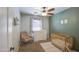 Bedroom room featuring a charming rocking chair, modern ceiling fan, and neutral-toned walls at 3893 E Gideon Way, Gilbert, AZ 85296