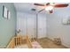 Bedroom room with a wooden crib, ample natural light, and modern ceiling fan at 3893 E Gideon Way, Gilbert, AZ 85296
