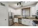 Well-lit kitchen featuring stainless steel appliances, granite countertops, and white cabinets at 3893 E Gideon Way, Gilbert, AZ 85296