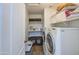 Laundry room featuring a washer, dryer, shelving, and natural light at 3893 E Gideon Way, Gilbert, AZ 85296