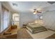 Spacious main bedroom suite with ample lighting, an attached bathroom, and a leather couch at 3893 E Gideon Way, Gilbert, AZ 85296