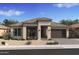 Beautiful single-story home with a stone-accented facade, desert landscaping, and a two-car garage at 42047 N Cutbow Trl, San Tan Valley, AZ 85140